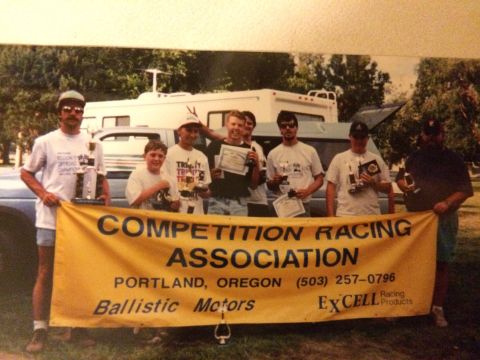 1989 Ford Bronco - A group of people are posing for a photo holding a banner and trophies.