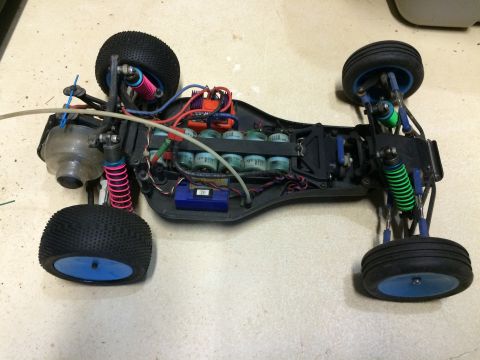 1989 Ford Bronco - The internal components of a remote control car are visible, including the battery pack and wiring.