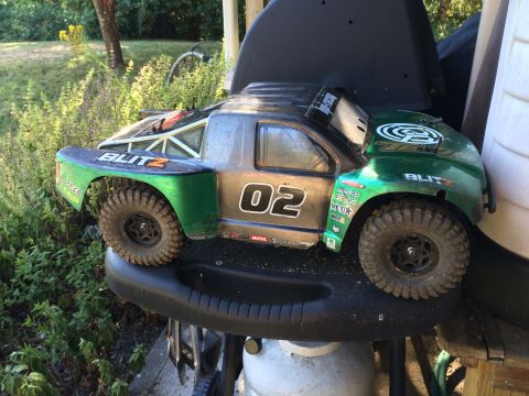 1989 Ford Bronco - This remote-controlled truck is green and gray with racing decals and the number 02 visible.
