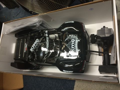 1989 Ford Bronco - A black remote control car, likely a model truck, is shown in its box with decals and a remote control.