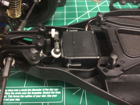 1989 Ford Bronco - Close-up of an RC car's chassis, highlighting the servo and suspension parts.