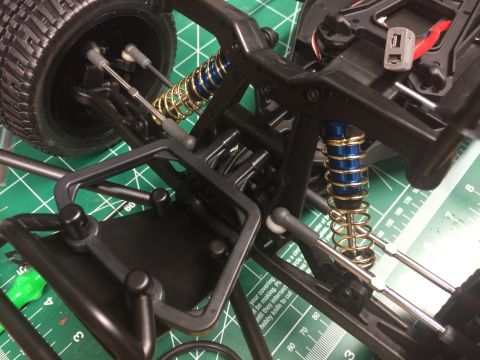 1989 Ford Bronco - Close-up of a remote control car's suspension system, showing its intricate mechanical components.