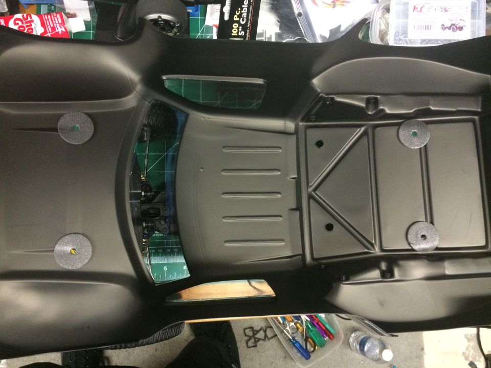Black plastic body for an RC car, showing the interior floor pan and seat area