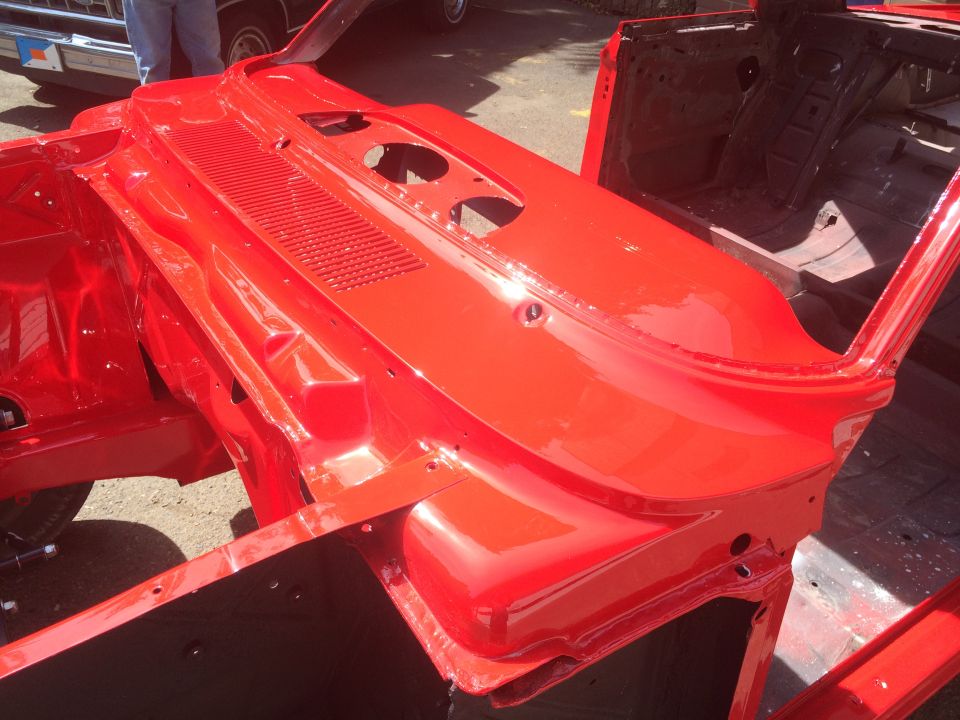 Red 1964 Ford Fairlane body shell, front view, showing firewall and inner fenders