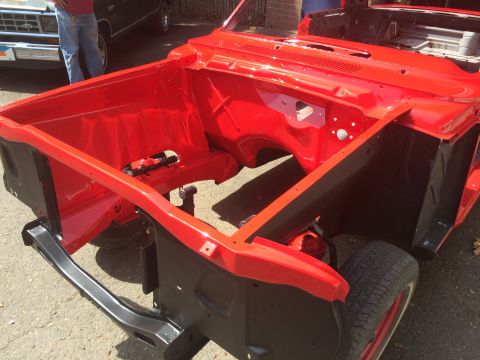1964 Ford Fairlane - Car chassis in red, possibly a 1964 Ford Fairlane, with a black frame and visible tire.
