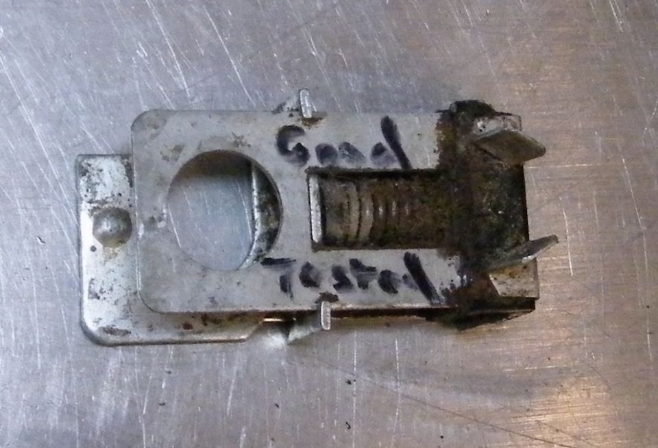 Metal vehicle part with "Good Tested" written in marker.