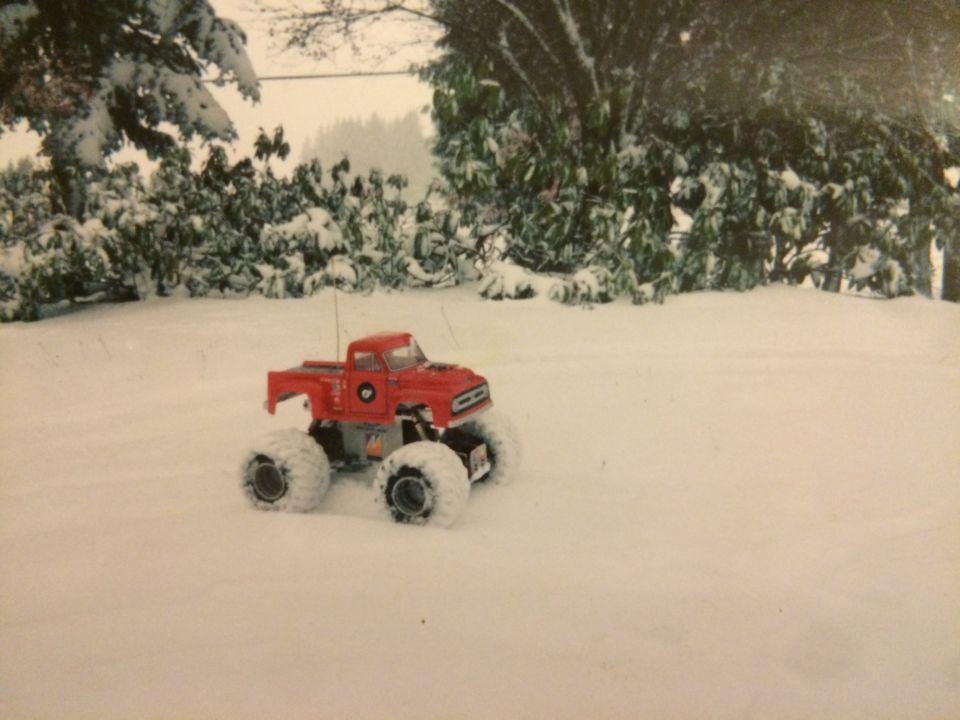 Red remote-controlled monster truck in the snow