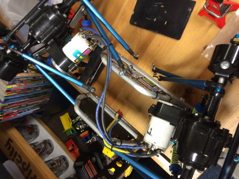 1989 Ford Bronco - The image shows a close-up, overhead view of the chassis and drivetrain components of a remote-controlled car, likely an off-road model, wi…