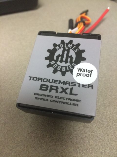 1989 Ford Bronco - A close-up view of a black electronic speed controller with a gray label that reads "TORQUEMASTER BRXL BRUSHED ELECTRONIC SPEED CONTROLLER"…