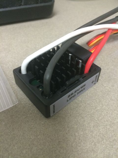1989 Ford Bronco - A close-up of an electronic speed controller (ESC) with multiple wires connected. The ESC has a black heatsink and a label that reads "25.2…