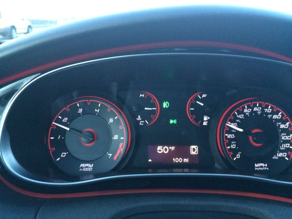 Dashboard of a 2015 Dodge Dart with tachometer, speedometer, and digital display.