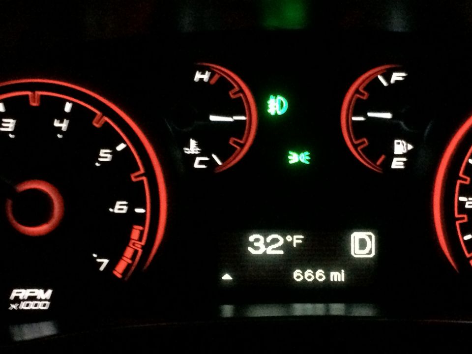 2015 Dodge Dart dashboard showing 32°F, D gear, 666 miles, tachometer, and fuel gauge.