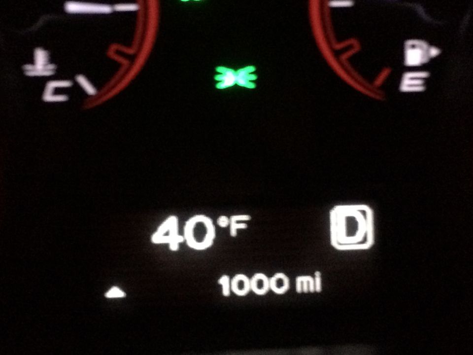 Car dashboard showing 40°F temperature and 1000 miles range.