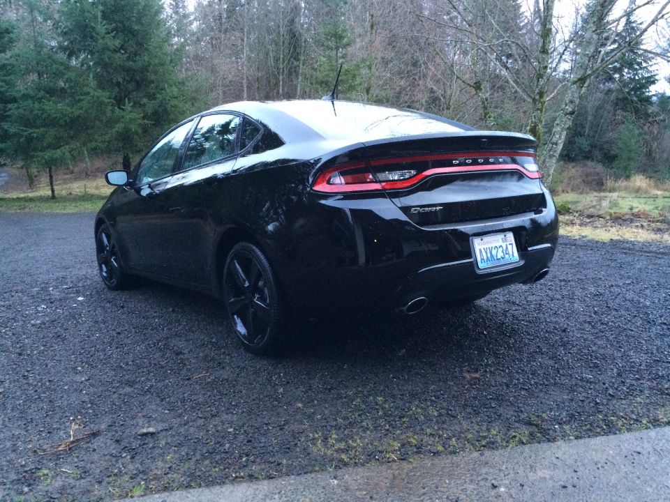 Black 2015 Dodge Dart parked outdoors, rear 3/4 view.