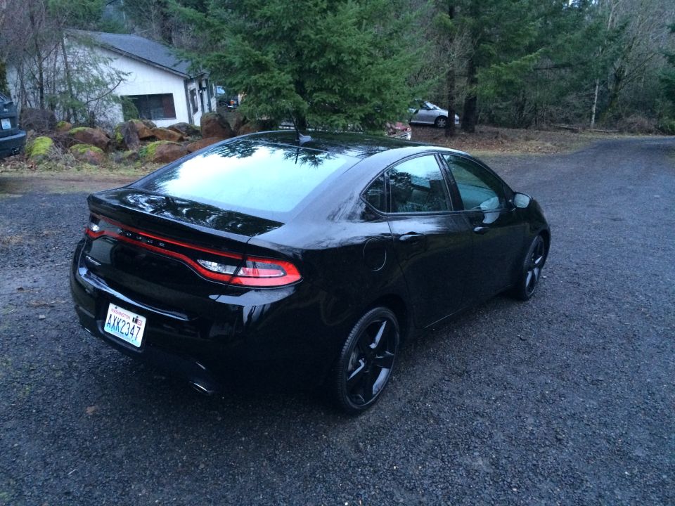 Black 2015 Dodge Dart sedan, rear passenger side view, Washington license plate AXK2347.