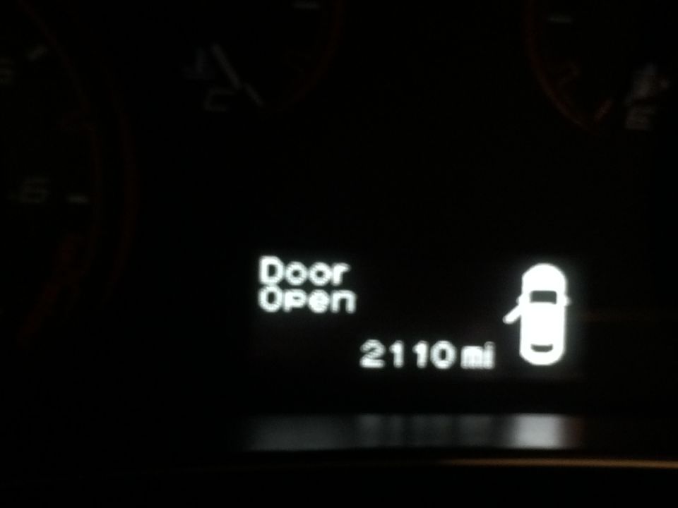 Gauges and digital display in a car interior at night