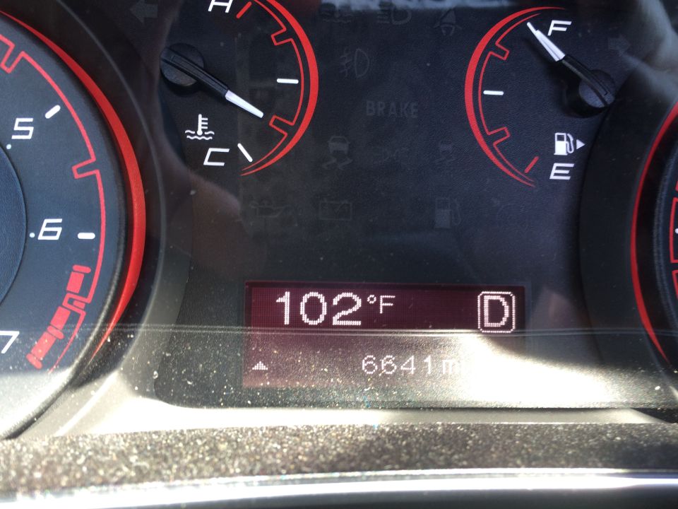 Car dashboard showing temperature at 102°F and 6641 miles. Gear selector is in 'D'