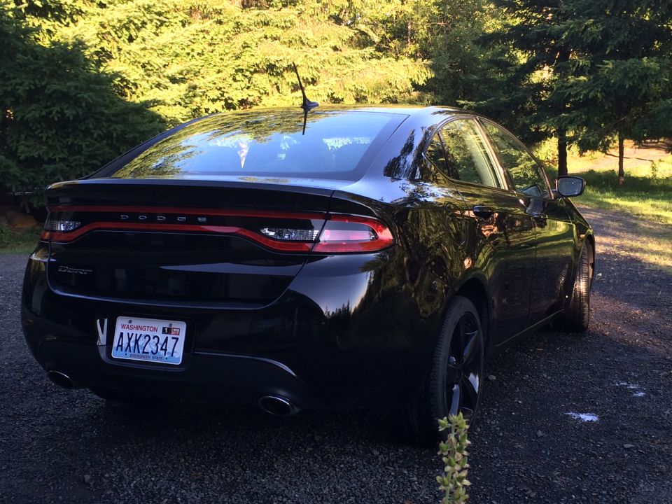 Black 2015 Dodge Dart sedan, rear driver-side quarter view, Washington license plate AXK2347