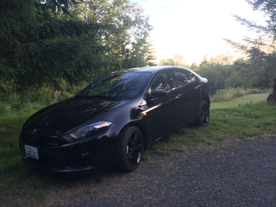 Black 2015 Dodge Dart sedan parked outdoors.