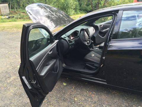 2015 Dodge Dart - The open driver's side door and hood of a black 2015 Dodge Dart reveal the interior and engine bay. The car is parked outdoors on a gravel…