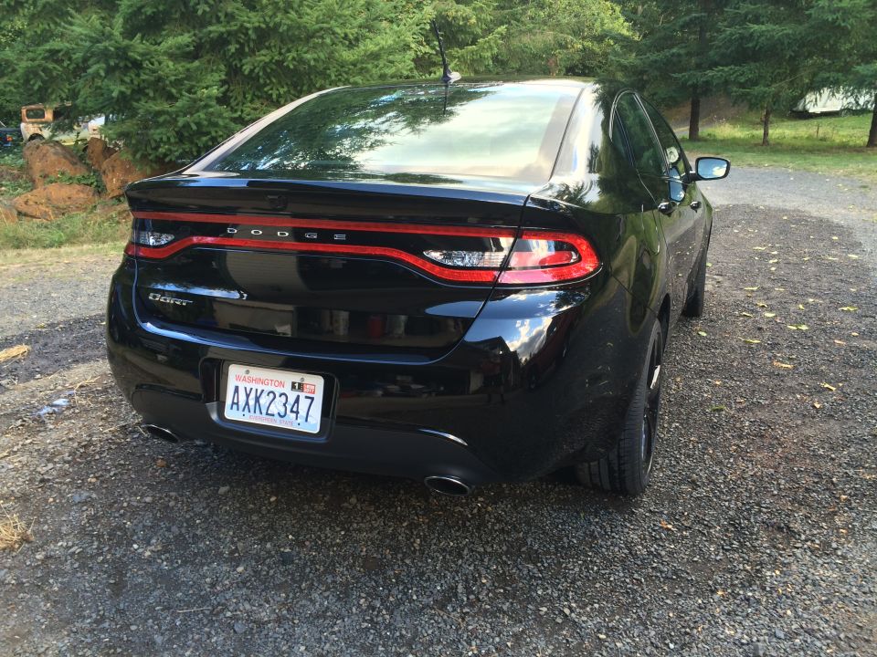 Black 2015 Dodge Dart sedan, rear driver's side quarter view, Washington license plate AXK2347.
