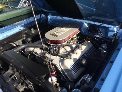 1962 Chevrolet Suburban - Close-up of a light blue classic car's engine bay, featuring a Ford 272 V8 engine with a chrome air cleaner and red filter. A green classic…