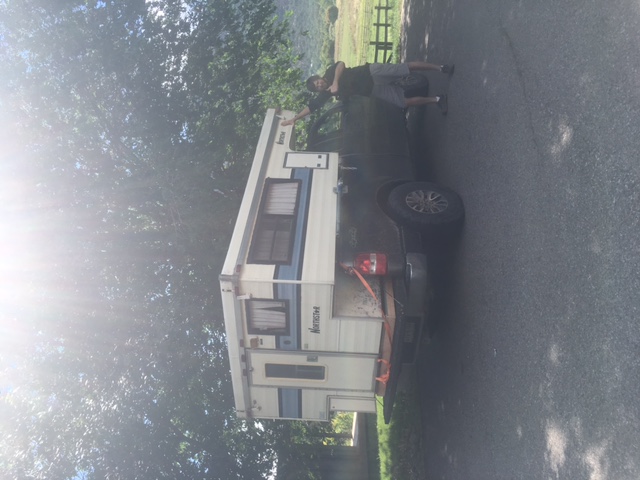 Man standing by a pickup truck with a Northstar camper shell.