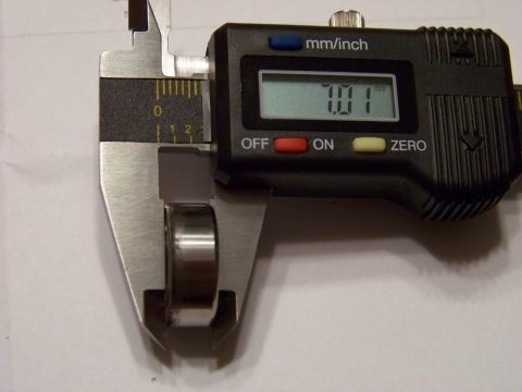 1999 Mercury Grand Marquis - A digital caliper measures the diameter of a small metal bearing. The caliper reads 7.01 mm.