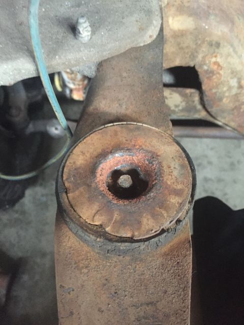 1978 Ford Bronco - This close-up shows a heavily rusted suspension part, possibly a bushing mount, with visible wear and corrosion.