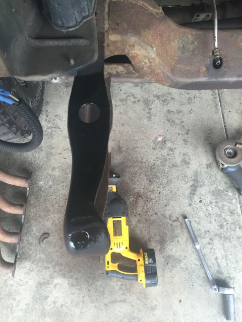 1978 Ford Bronco - Close-up view of a vehicle's frame component and a DeWalt reciprocating saw on a concrete surface.