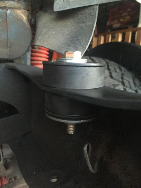 1978 Ford Bronco - A suspension lift block is installed on the vehicle's frame, showing a portion of the suspension system.