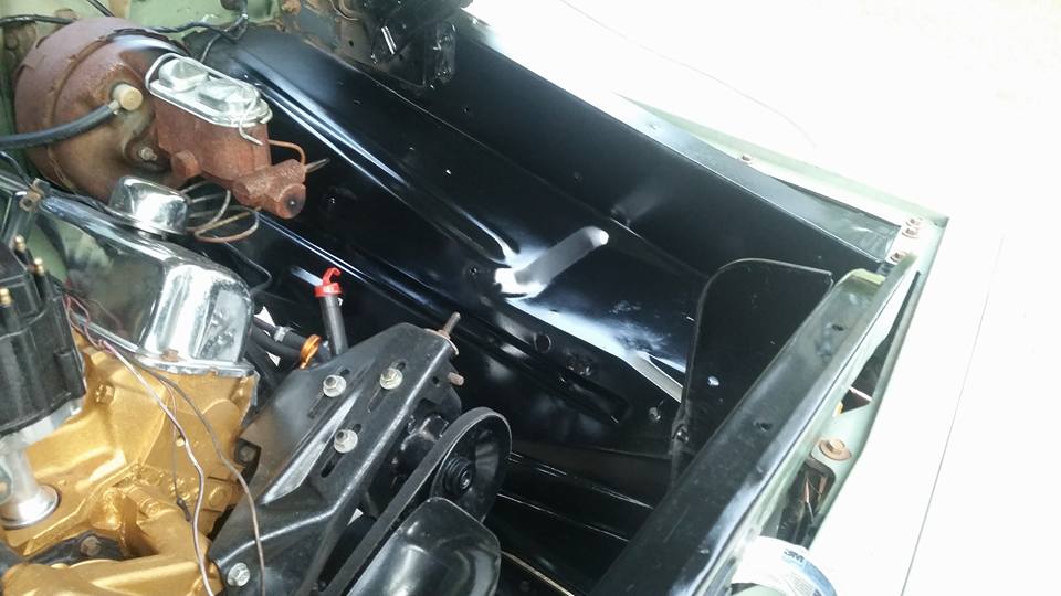 Engine bay with master cylinder and gold-painted engine block