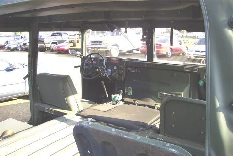1995 Ford Bronco - View from inside a Humvee, looking out at a parking lot with several other vehicles.