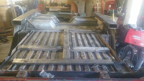 1979 Ford Bronco - Custom metalwork being added to a vehicle frame in a workshop setting.