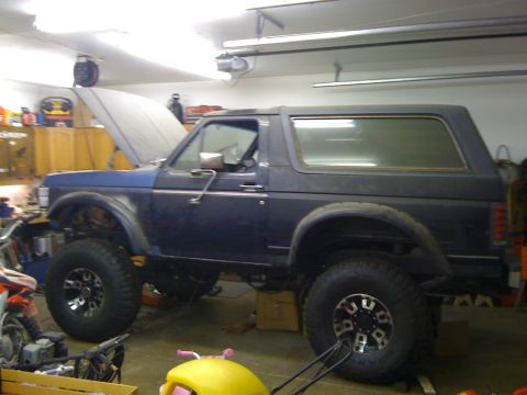 1988 Ford Bronco - This 1988 Ford Bronco is seen in a garage with its hood open and lifted suspension.