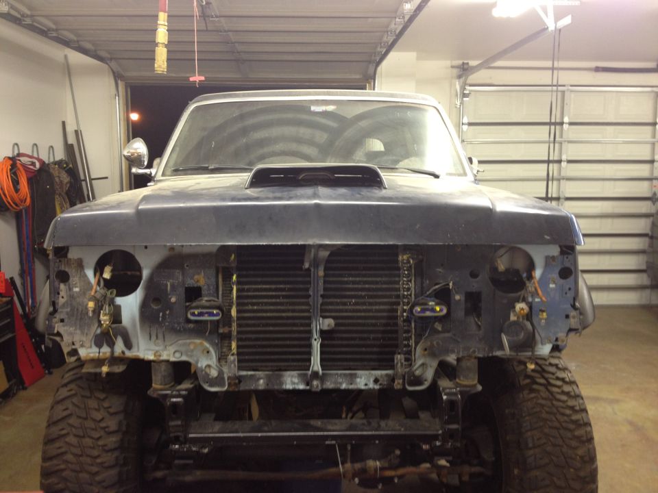 1988 Ford Bronco front end with grille removed, hood scoop, and missing headlights