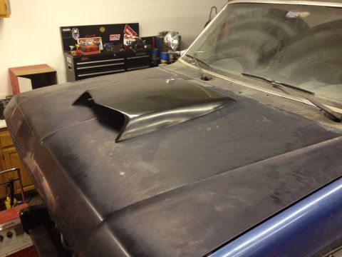 1988 Ford Bronco - A car hood with a black scoop is shown in a garage setting, with a toolbox visible in the background.