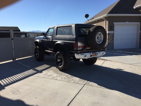1988 Ford Bronco - Rear view of a modified Ford Bronco parked in a driveway.