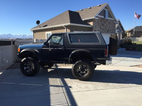 1988 Ford Bronco - This 1988 Ford Bronco is parked in front of a house on a sunny day.