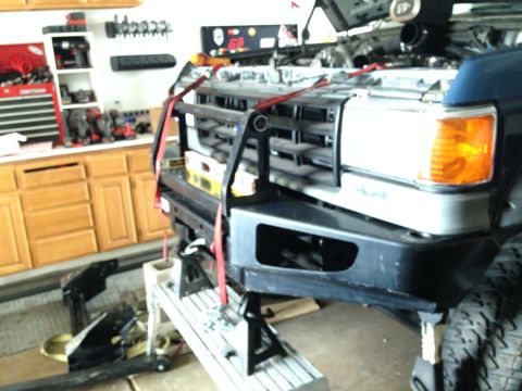 1988 Ford Bronco - This Ford truck is undergoing maintenance, with its front end elevated on jack stands and a heavy-duty bumper installed.