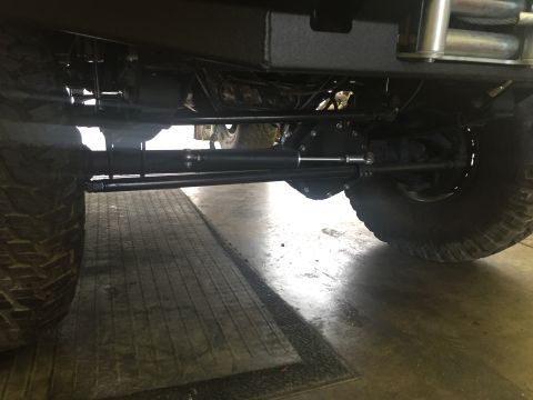 1988 Ford Bronco - Undercarriage view of a vehicle's rear axle and steering components, with a Supermotors.net watermark.