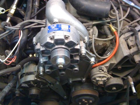 1988 Ford Bronco - Engine bay detail showing a supercharger installation with associated plumbing and wiring.