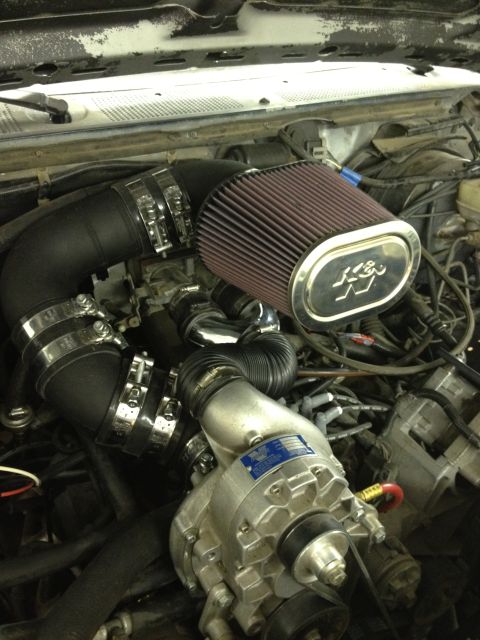1988 Ford Bronco - Close-up view of an engine bay a supercharger and K&N air intake system.