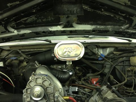 1988 Ford Bronco - Close-up of an engine bay a K&N air filter and a supercharger. Text from SuperMotors.net is visible.
