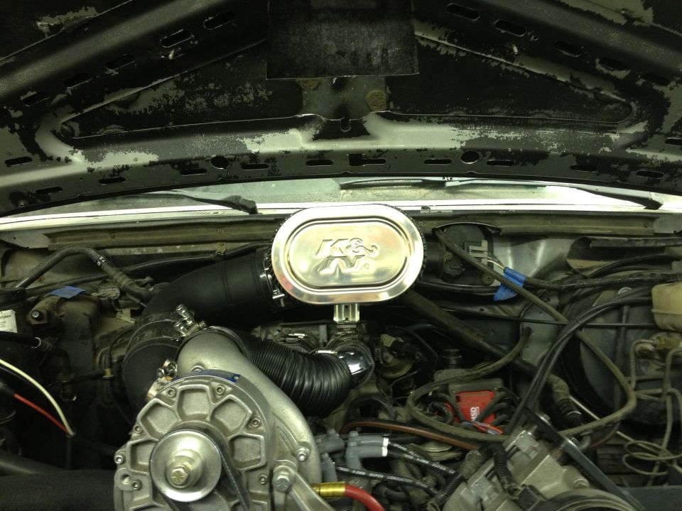 Engine bay showing K&N air filter, supercharger, and wiring. SuperMotors.net logo visible