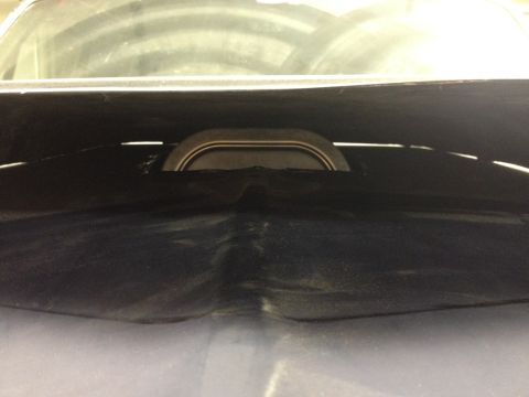 1988 Ford Bronco - The image shows a dark-colored engine air intake component with a metallic trim ring.