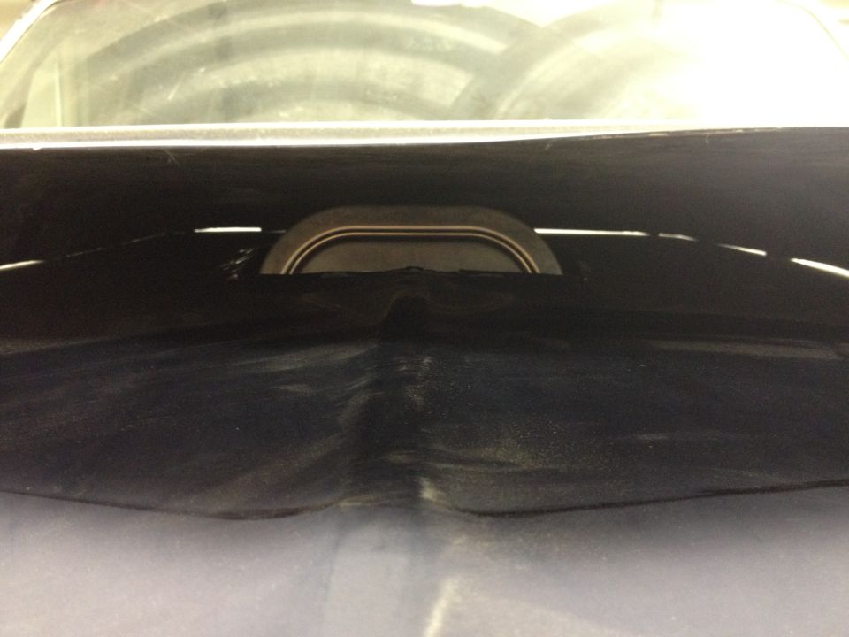 Close-up of an engine air intake assembly, likely under a hood