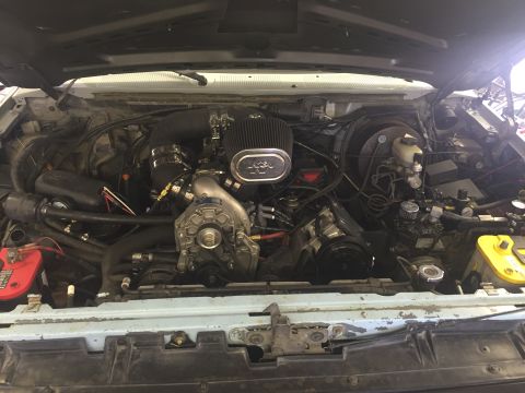 1988 Ford Bronco - Custom engine bay features a K&N air filter and a prominent supercharger, suggesting performance modifications.