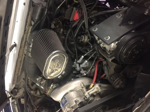 1988 Ford Bronco - Close-up view of a vehicle's engine bay, a K&N air filter and a supercharger.