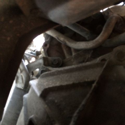 1988 Ford Bronco - Undercarriage view shows a section of the exhaust system and associated hardware.